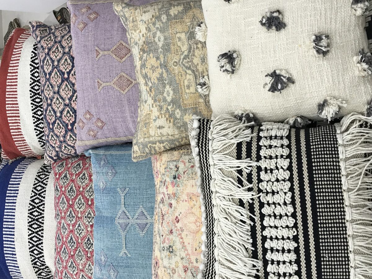 Stack of handwoven and tufted cushion covers