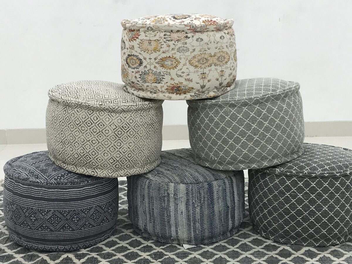 Stacked woven poufs in natural tones