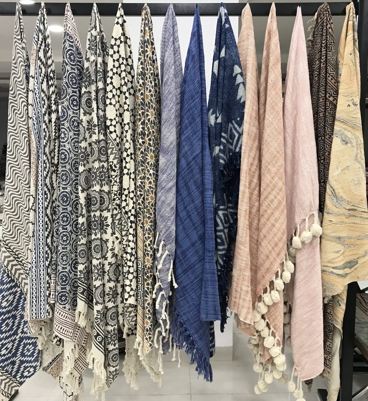 Throws in woven patterns hanging in a row